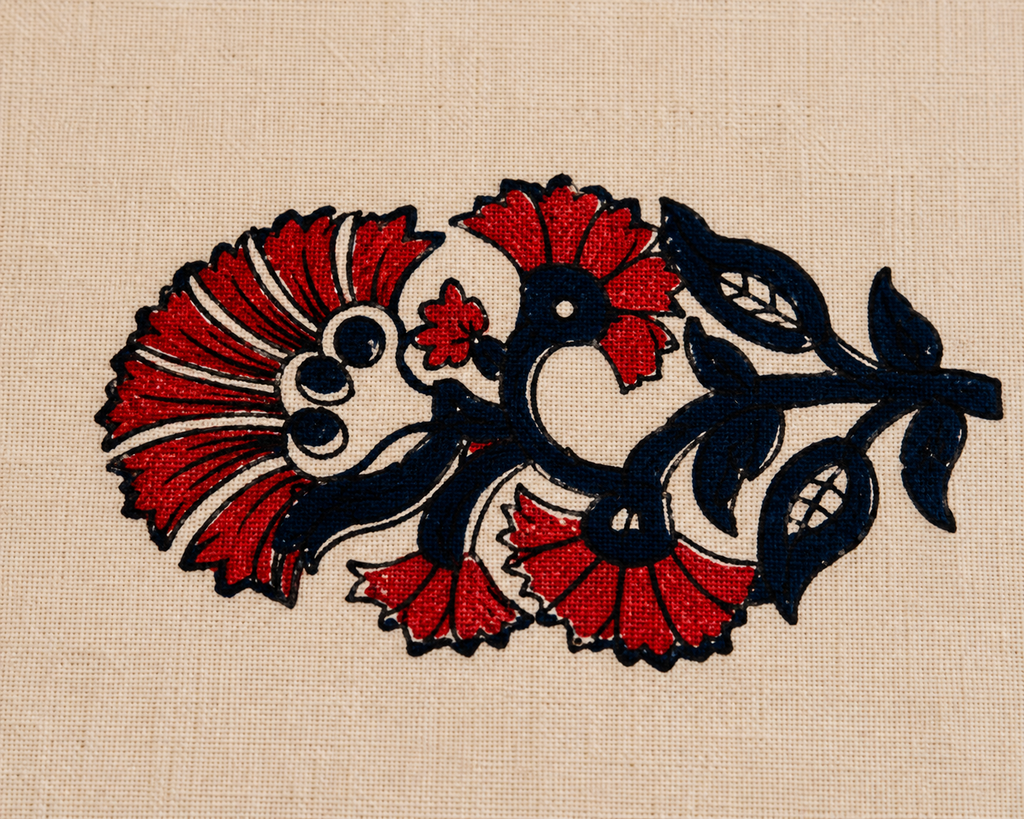 A close-up of a beige woven fabric featuring a stylized floral embroidery design in red and black thread.